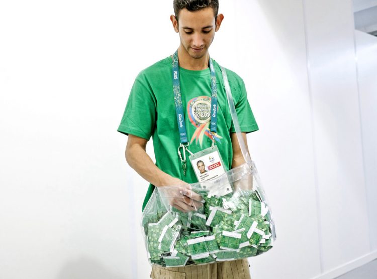 rs_1024x759-160812132903-1024-rio-staff-member-handing-out-condoms-olympic-village-081215